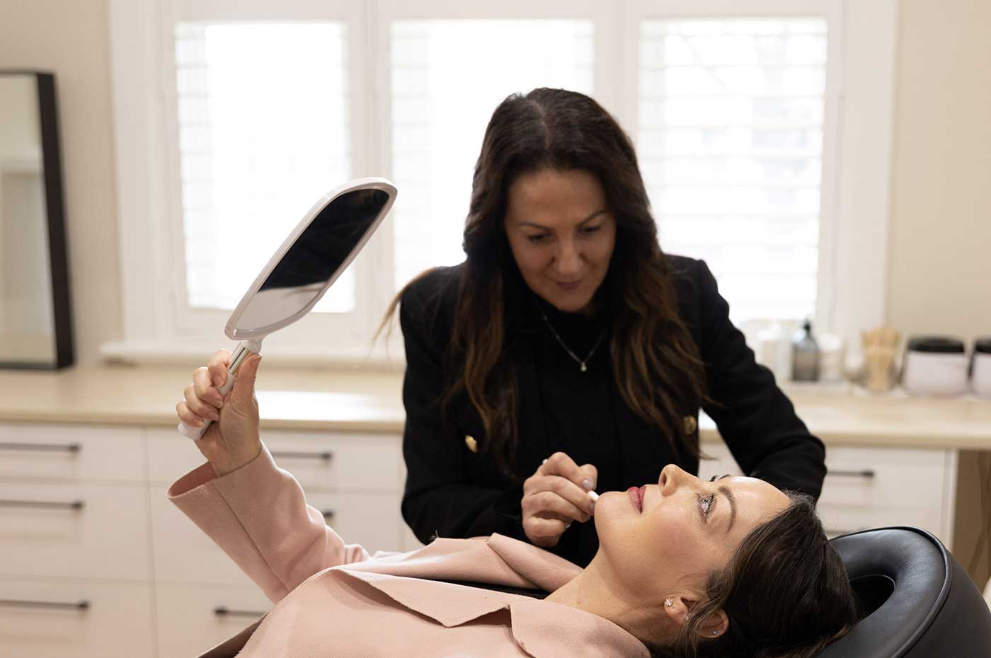 About Face Clinic Michelle Kennedy preparing client for skin treatment